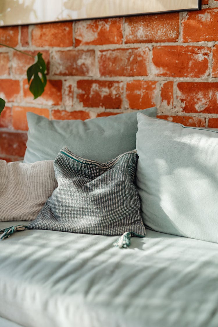 Cozy Couch On Brick Wall Background At Home