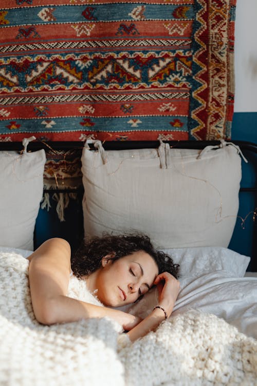 A Woman Lying in Bed and Resting