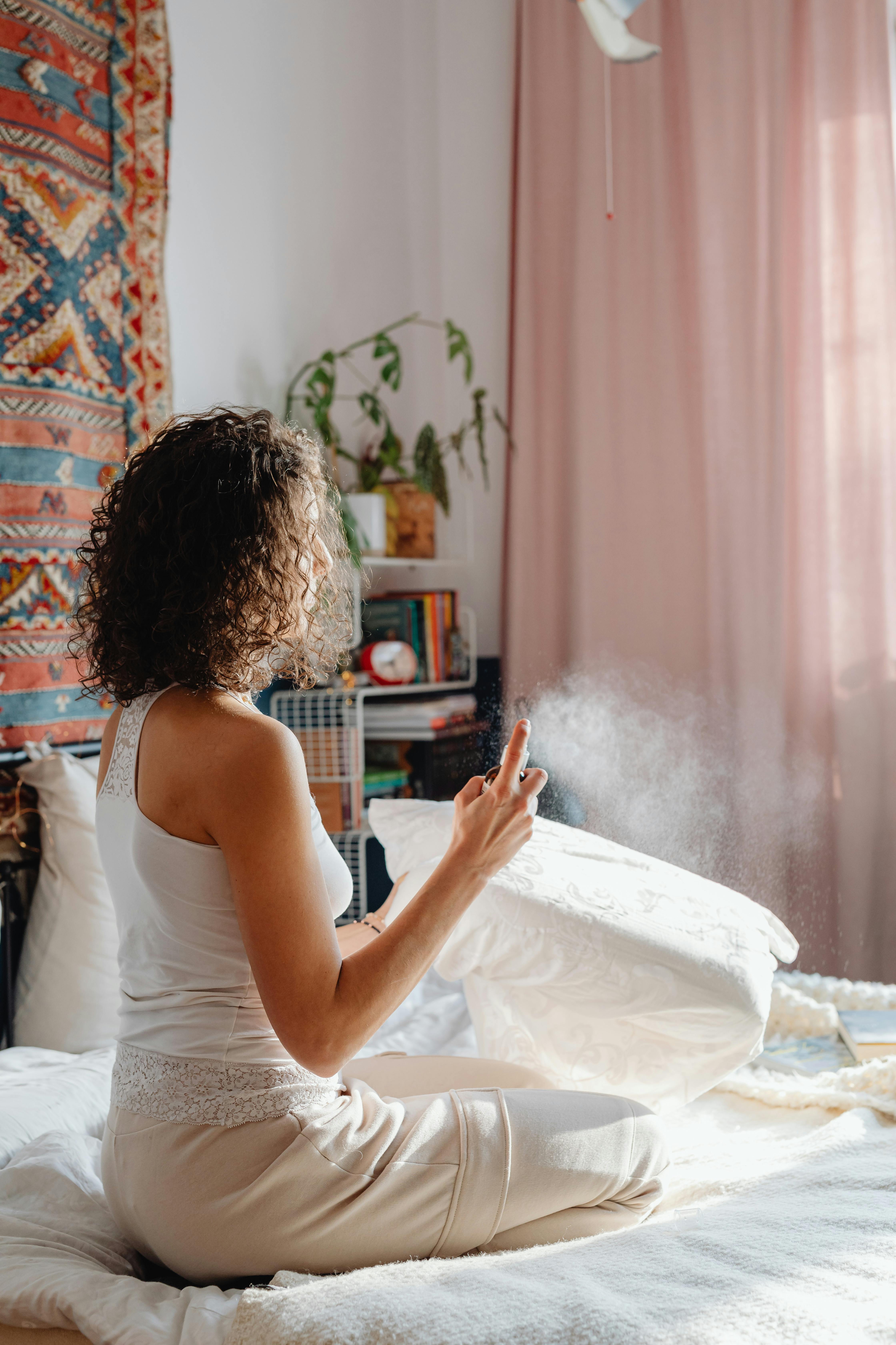 A Woman Disinfecting Her Pillow · Free Stock Photo