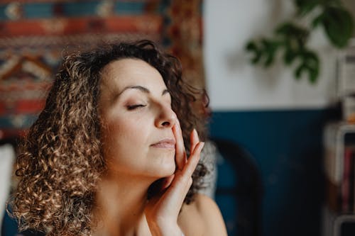 Woman Applying a Face Cream 