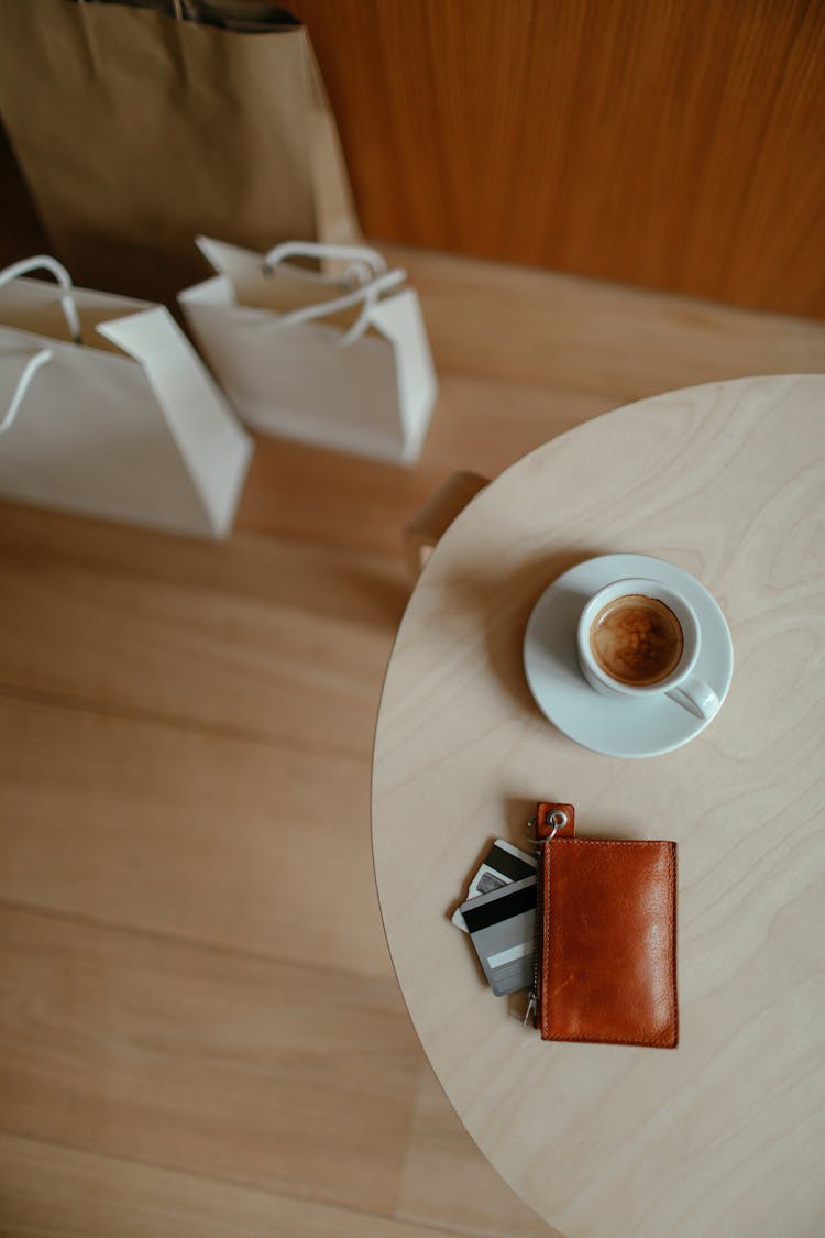 Coffee And A Wallet On A Wooden Table