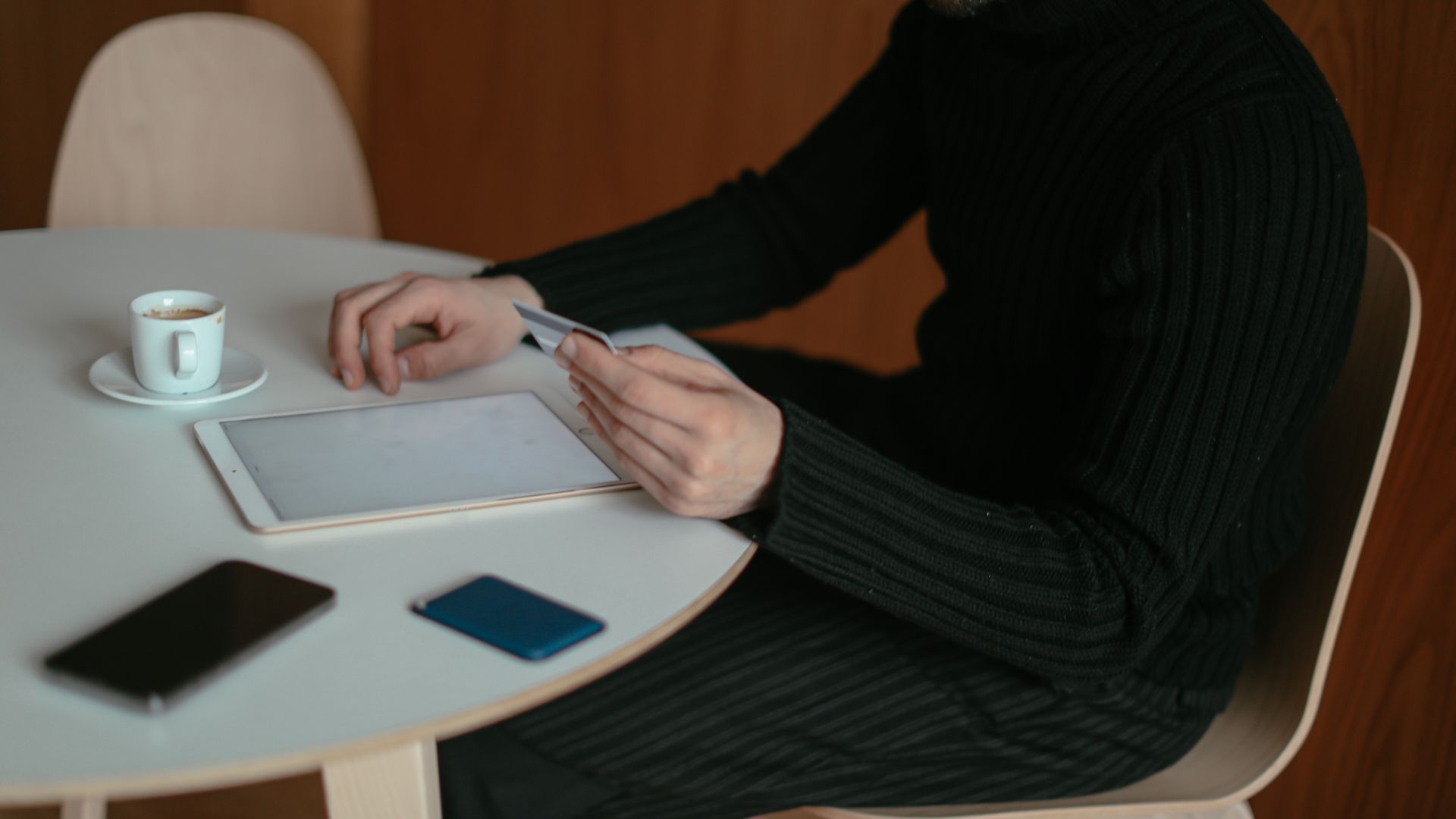 Ordering Modafinil Online: A Comprehensive Guide Adult man using tablet and credit card to shop online at home, sitting by table with coffee.