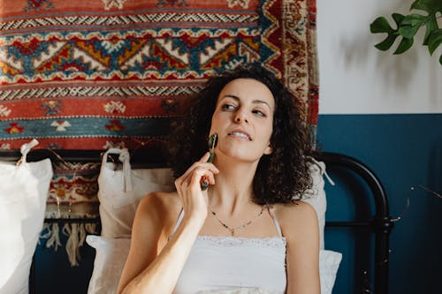 Woman Using Jade Roller on Face