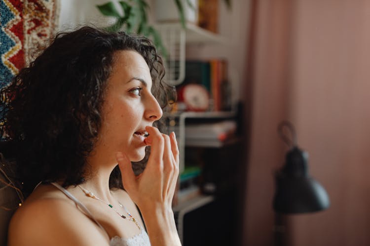 Woman Applying Lip Balm 