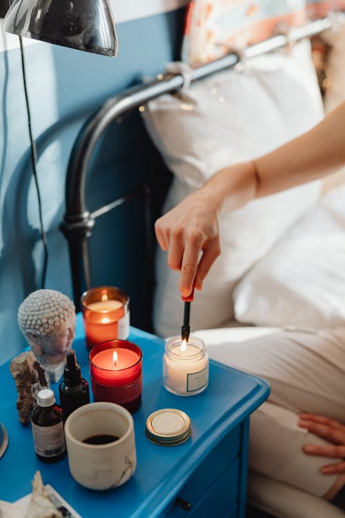 Free Person Lighting a Candle Using a Lighter Stock Photo