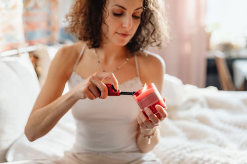 Free Woman Lighting a Red Candle  Stock Photo