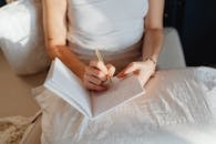 Woman Writing on a Notebook