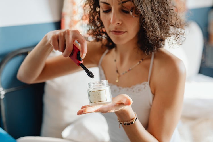 A Woman Lighting A Candle