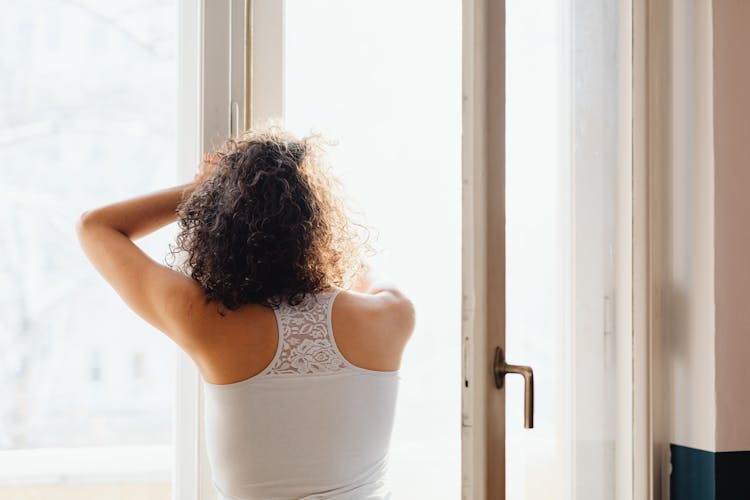 Woman Looking Though Window