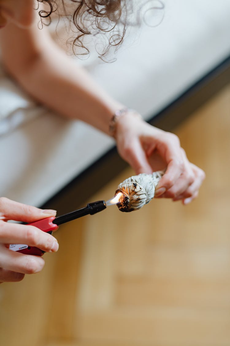 Woman Lighting Incense In Close Up