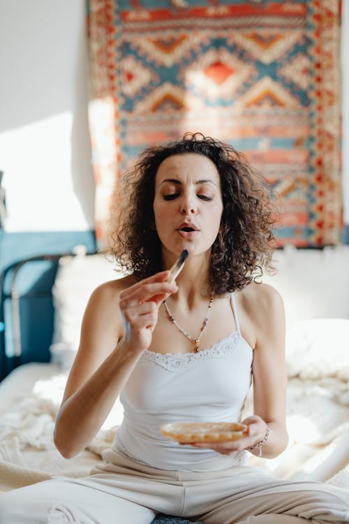 Portrait of a Young Woman Burning an Incense Stick in a Bedroom