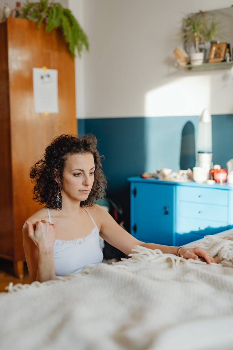 Woman Meditating In Bedroom