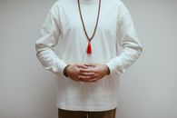 Woman in White Long Sleeve Shirt Wearing Gold Necklace