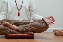 Close-up of a person meditating in a serene indoor setting, focusing on mindfulness.
