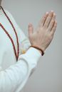 Person in White Long Sleeve Shirt Wearing Gold Bracelet