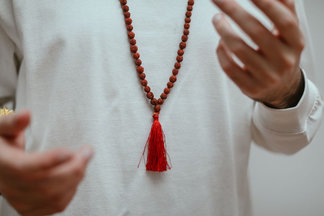 A Rudraksha mala arranged on fabric