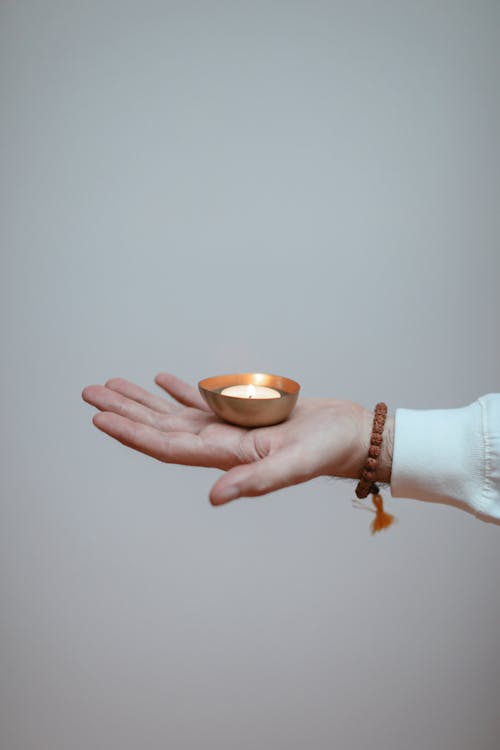 Person Holding a Burning Candle