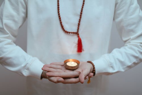 Person Holding a Burning Candle