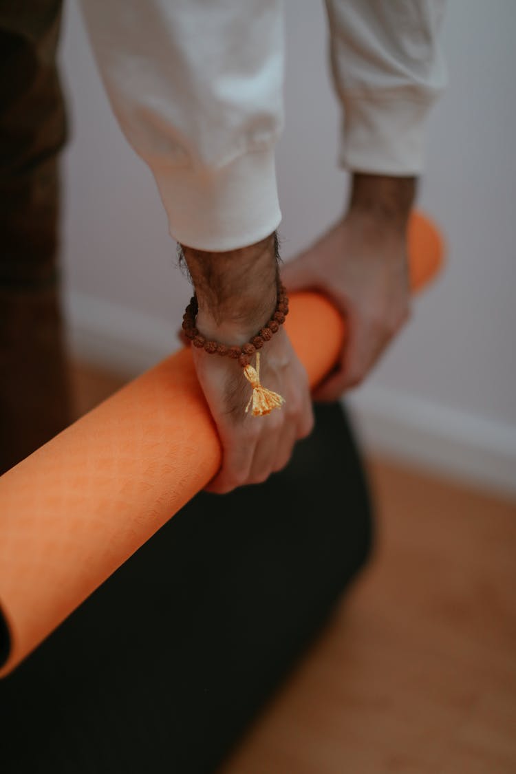 Yogi Rolling A Yoga Mat