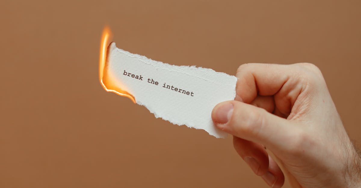 Hand Holding a Burning Note · Free Stock Photo