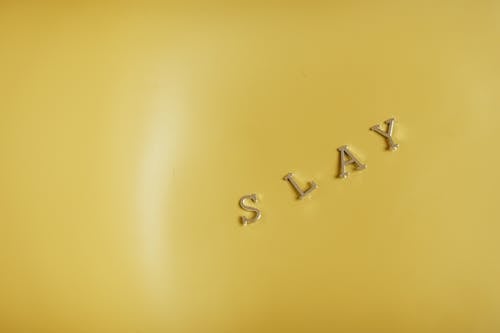 Slay Word against a Yellow Background