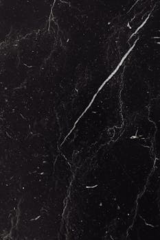 High-resolution black marble texture with natural white veins. Ideal for backgrounds, design, or decor projects.