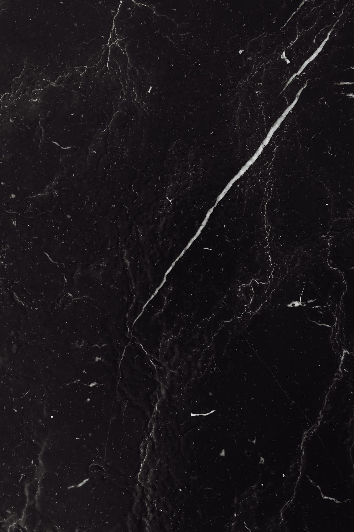 Black marble surface with striking white veins