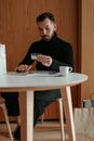 Confident young man using tablet and doing online shopping at home