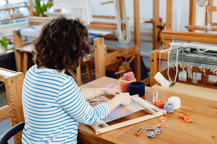 Woman Weaving On Small Loom