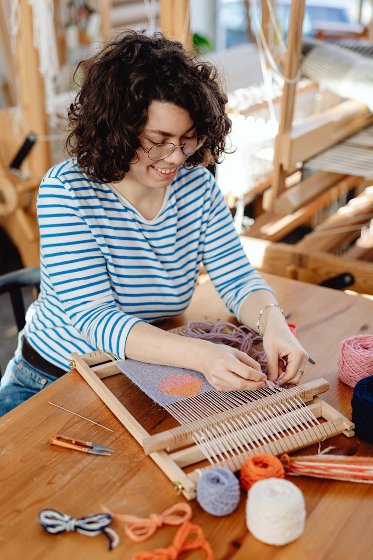 Woman Weaving With Colorful Threads 