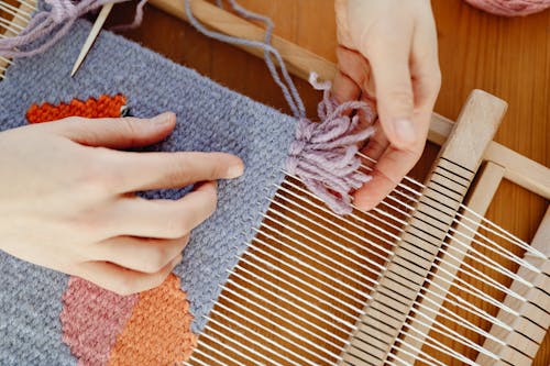Person Weaving with Wool Threads