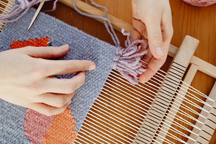 Person Weaving With Wool Threads