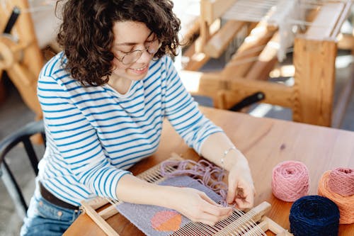 Woman Weaving with Wool Threads on Machine