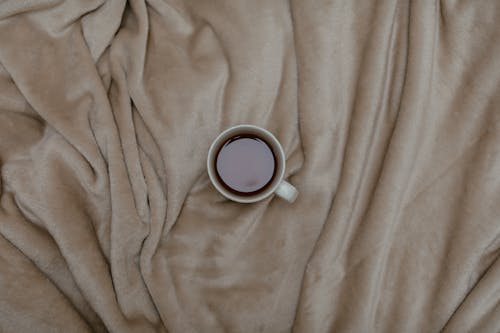 Cup of Coffee on Top of a Blanket 
