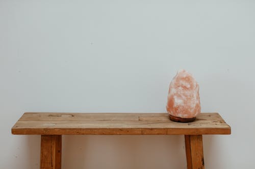 Free Himalayan Salt Lamp on a Wooden Bench Stock Photo