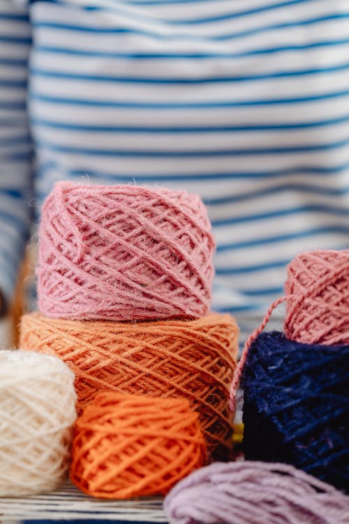 Piles of Wool Threads Bobbins