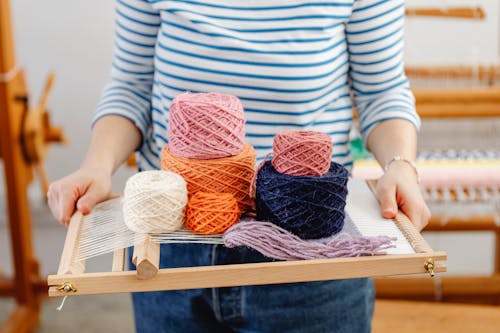 Free Woman Holding a Weaving Loom and Yarn Stock Photo