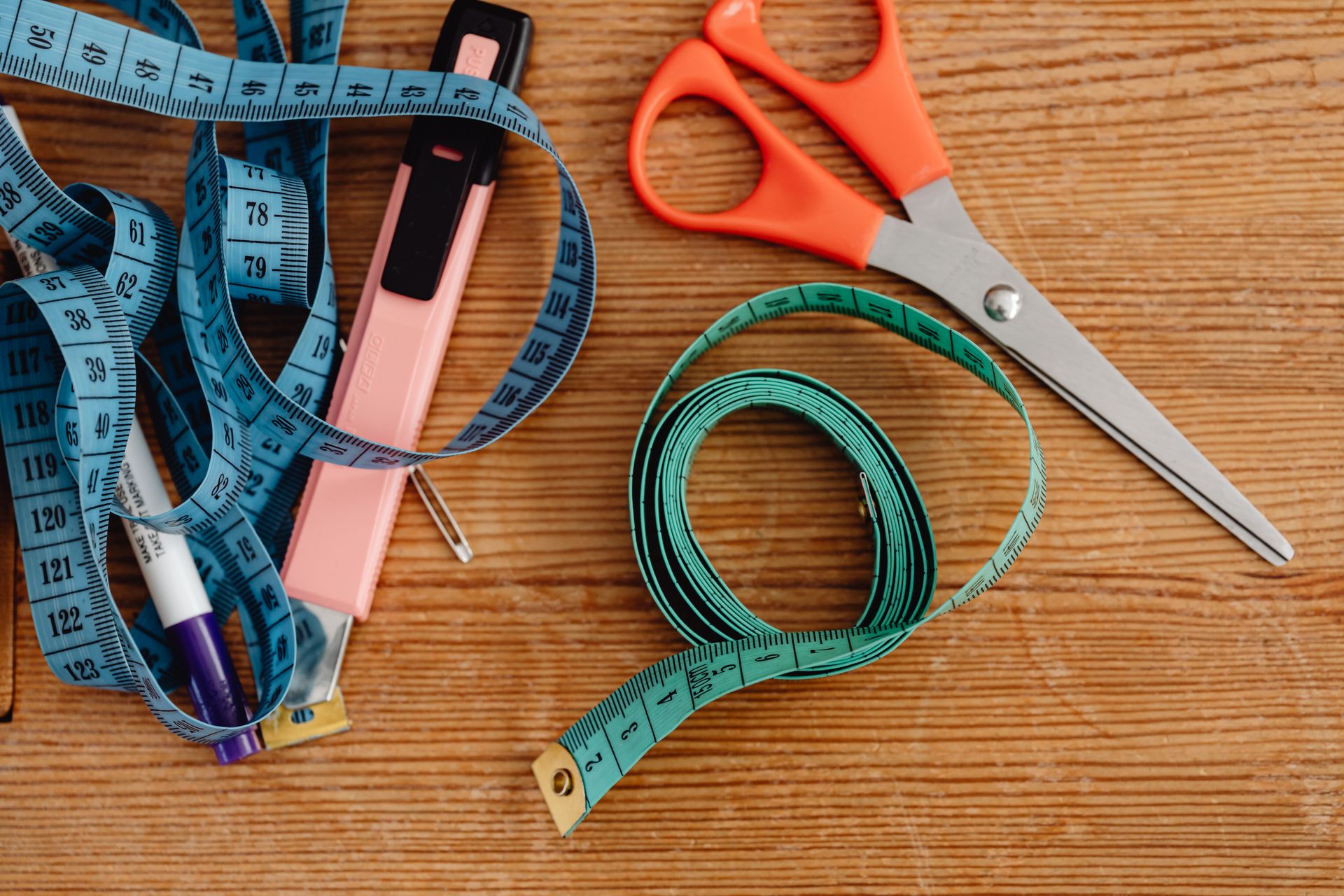 Cutting Tools and Tape Measures on the Wooden Table