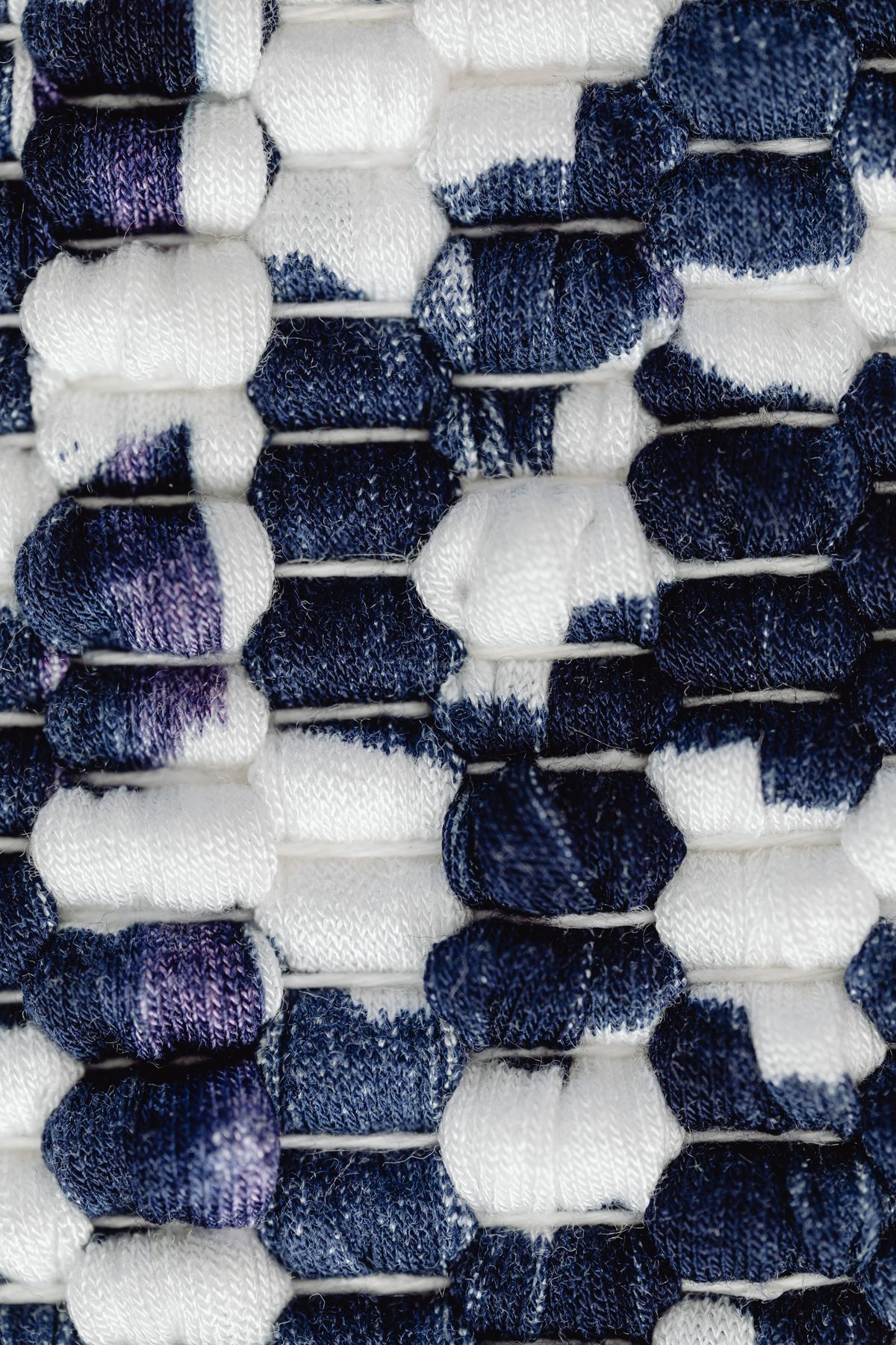 Close-up of a blue and white woven cotton fabric showing the tight, even weave typical of a classic cotton tea towel