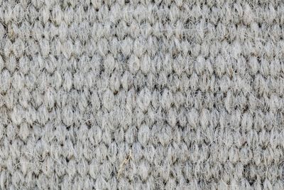 Macro of grey knitted wool fabric texture