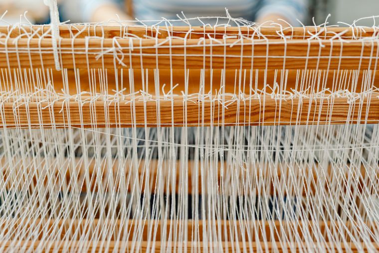 Warp threads under a loom reed — photo by Kaboompics on Pexels