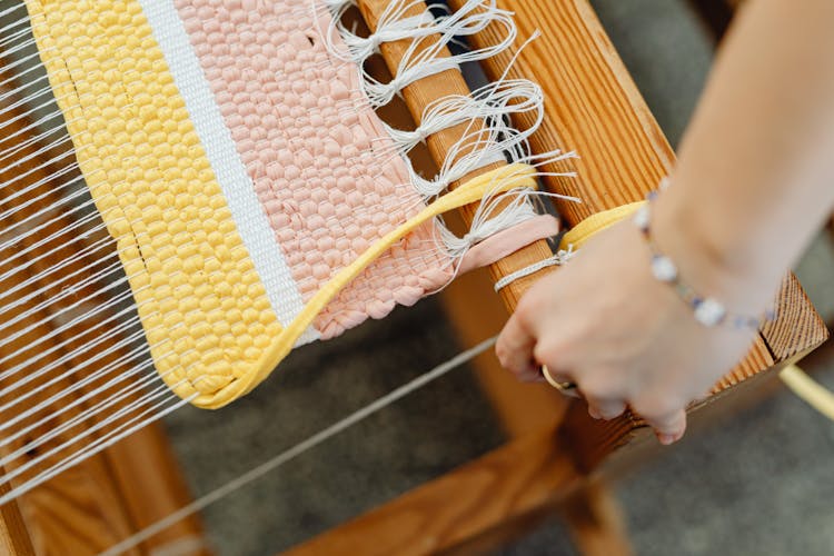 Close-up Of Weaving On Machine With Wool Threads