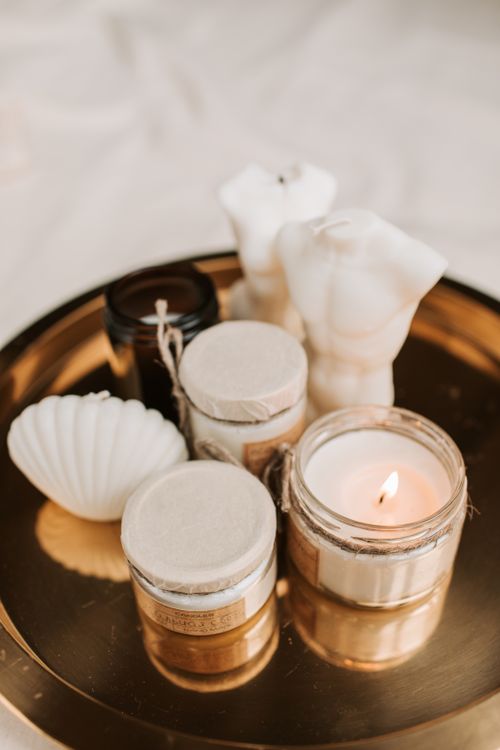 Free Elegant setup of candles and skincare products for a serene wellness experience. Stock Photo