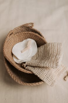 Eco-friendly skincare essentials featuring a jute basket, cotton pads, and a natural washcloth.