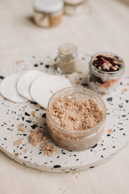 Free Flat lay of natural scrub and cotton pads for eco-friendly skin care routine. Stock Photo