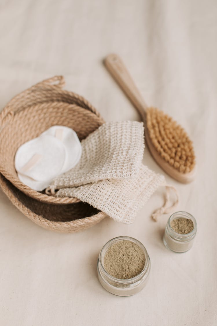 Hemp Washcloth And Cotton Pads In Braided Jute Basket Beside A Brush