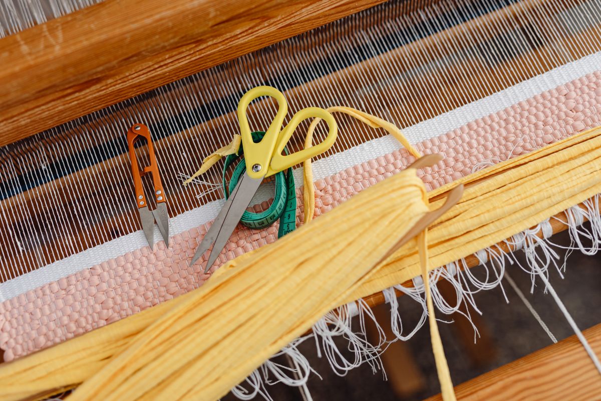 Textile tools, yarn and woven fabric close-up