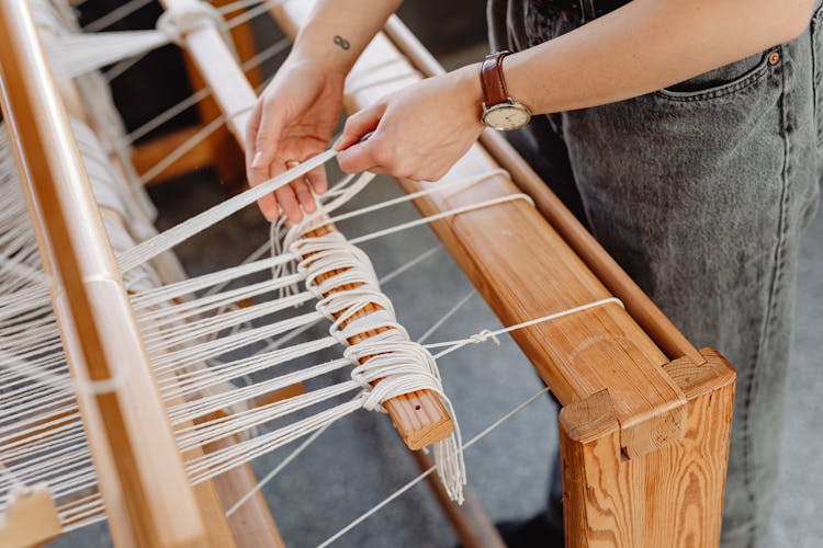 Woman Making Handmade Rug With Wool Threads