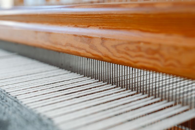 Close-up of threads aligned on a weaving loom