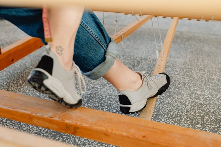 A Person Stepping On The Wooden Rod